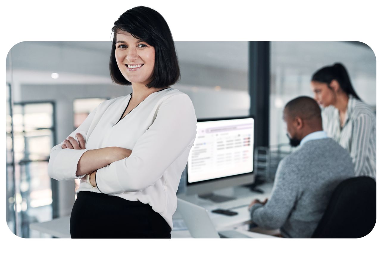 Business professional working on laptop while reviewing IgniteDemand Pro dashboard